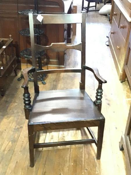 An early 19th century oak Glasgow pattern open armchair, with shaped horizontal splat above a