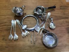 A mixed lot of silver, white metal and silver plate including a tea strainer, cream jug, ashtrays,