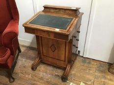 A late Victorian walnut and yew-wood banded Davenport, the raised top with hinged lid above a