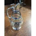 A 20thc crystal barrel shaped claret jug with wheel cut panels and plated banded mounts, H 24cm x