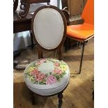 A late Victorian walnut nursing chair c.1890, the upholstered oval back above a tapestry seat on