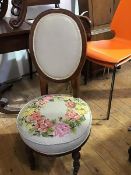 A late Victorian walnut nursing chair c.1890, the upholstered oval back above a tapestry seat on