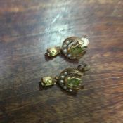 An Edwardian pair of 9ct gold peridot and pearl set crescent yellow metal earrings (3.2g)