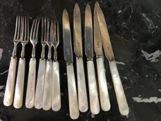 A set of 11 mother of pearl handled and silver bladed fruit knives and forks (11)