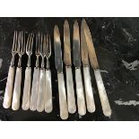 A set of 11 mother of pearl handled and silver bladed fruit knives and forks (11)