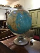 A Mid Century illuminating terestrial Atlas globe on perspex and metal stand (h.59cm x 43cm)