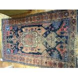A 1920's Caucasian rug, the centre panel with geometric decoration, multiple flowerhead border (