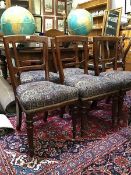 A set of six Victorian oak dining chairs, each with tapered back and chamfered mid-rail, above