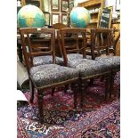 A set of six Victorian oak dining chairs, each with tapered back and chamfered mid-rail, above