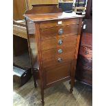 An Edwardian mahogany and satinwood inlaid sheet music cabinet, the shaped ledge back on rectangular