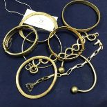 A collection of silver and white metal bangles and bracelets including a hinged engraved bangle, a