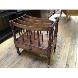 A 19thc mahogany canterbury, fitted four sections, raised on turned supports (one spindle