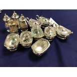 A Sheffield plated 12 piece condiment set comprising four mustards , four salt cellers and four