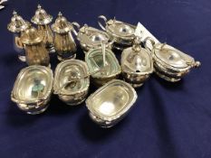 A Sheffield plated 12 piece condiment set comprising four mustards , four salt cellers and four