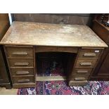 An Edwardian oak twin pedestal kneehole desk (converted from roll top), the rectangular top with