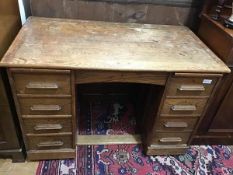 An Edwardian oak twin pedestal kneehole desk (converted from roll top), the rectangular top with