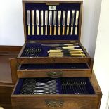 An oak cased silver plated canteen of Old English flatware, with hinged top above two fitted