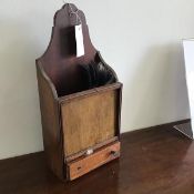 A 19thc mahogany candlebox, the shaped top to open compartment, with plain panel above a single