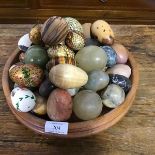 A turned treen bowl (d.28cm) containing a large quantity of alabaster, onyx and treen painted