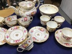 A 19thc handpainted floral decorated and gilded part teaset, comprising sugar bowl, cups and saucers