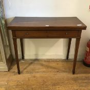 A 19thc mahogany foldover tea table, the rectangular top with boxwood stringing, above a single