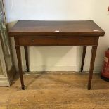 A 19thc mahogany foldover tea table, the rectangular top with boxwood stringing, above a single