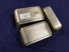 A set of three silver backed engine turned hairbrushes (larges: 11cm x 6cm)