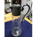 A pewter mounted claret jug, with hinged top and glass tapered base with star and circle engraved