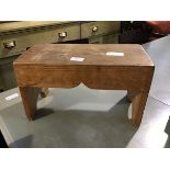 A small pitch pine dairy stool, the rectangular top with plain sides on plank supports (22cm x