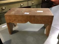 A small pitch pine dairy stool, the rectangular top with plain sides on plank supports (22cm x