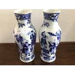 A pair of late 19thc Chinese blue and white exportware baluster vases, depicting tradesman and