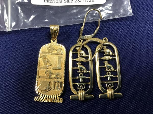 A pair of Egyptian design yellow metal earrings marked 975 together with a pendant of similar design