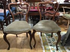 A pair of Victorian mahogany side chairs, the shaped top with carved top rail, with shaped