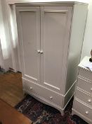 A Victorian style white painted wardrobe, the plain top with moulded edge above a pair of panelled