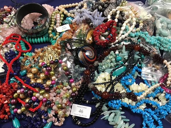 A box containing a large quantity of mixed beads and necklaces, including freshwater pearls,