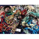 A box containing a large quantity of mixed beads and necklaces, including freshwater pearls,