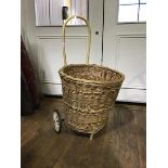 A circular wicker pull along shopping trolley (including handle h:86cm)