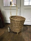 A circular wicker pull along shopping trolley (including handle h:86cm)