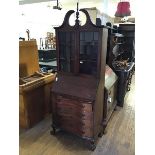 An stained mahogany American Federal style bureau bookcase, the arched pedimented top above two