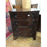 A reproduction bow front chest of drawers, the plain top above four long drawers, with shaped apron,
