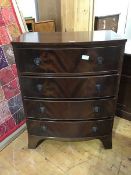 A reproduction bow front chest of drawers, the plain top above four long drawers, with shaped apron,