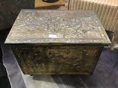 A brass covered wooden fireside bucket with embossed tavern scenes (38cm x 51cm x 34cm)