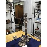 A silver plated three branch candelabra together with a squat three branch candelabra on circular