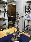 A silver plated three branch candelabra together with a squat three branch candelabra on circular