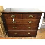An Edwardian stained chest of drawers, the rectangular top above two short and three long