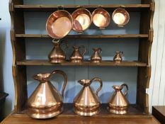 A set of seven 19thc. style copper tavern measures, two gallons reducing to gill, lead solder to