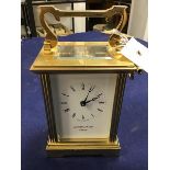 A Mappin & Webb London brass four glass clock, with white enamelled dial and roman numerals,