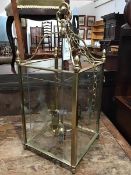 A 19thc. style hall lantern, the cast top with four arms leading to a cage of four glazed panels