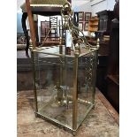 A 19thc. style hall lantern, the cast top with four arms leading to a cage of four glazed panels