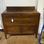 An Edwardian mahogany and checker banded chest, fitted three drawers and a pair of inset panel
